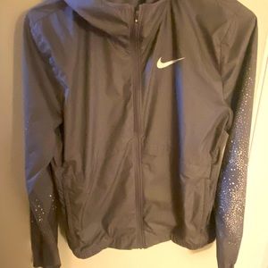 Nike hooded athletic jacket. Design on sleeves. Great condition.